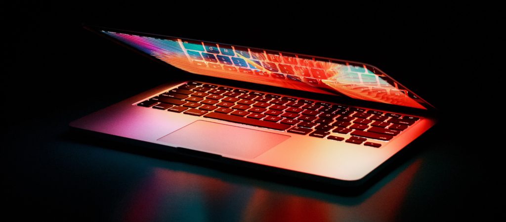 A half-open laptop in the dark